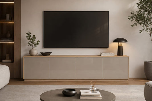 TRENZY Spaces Lux TV stand in a modern living room with a sleek beige finish and light wood base under a wall-mounted TV