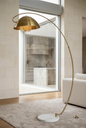 Brass arc floor lamp in a bright luxury interior
