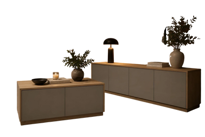 TRENZY Spaces Lux TV stand in grey and light wood finish, styled in a modern living room with brick wall background.