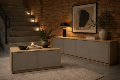 TRENZY Spaces Lux TV stand in a modern living room with light wood and grey finish against a brick wall